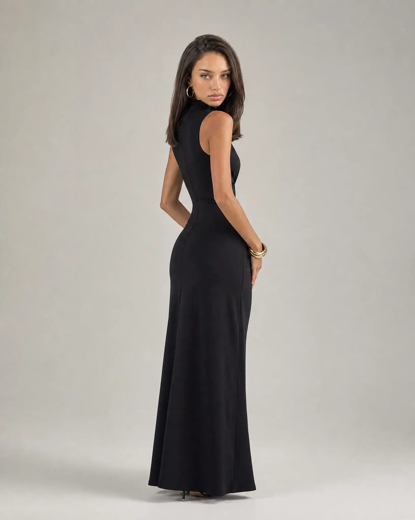 Black high neck ruched maxi dress for women by Ilynora, side view highlighting the fitted silhouette and waist detail