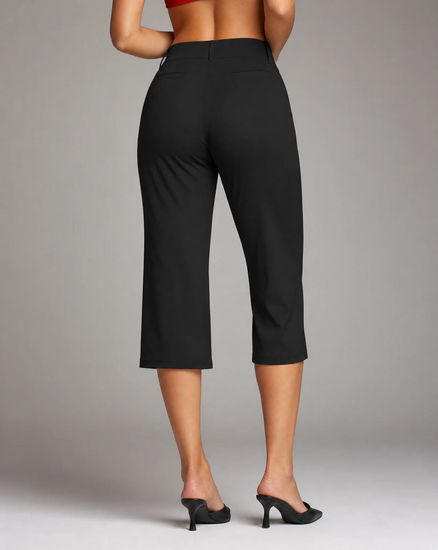 Women's black stretch capri trousers with comfortable slim fit, cropped length and back view by ILYNORA