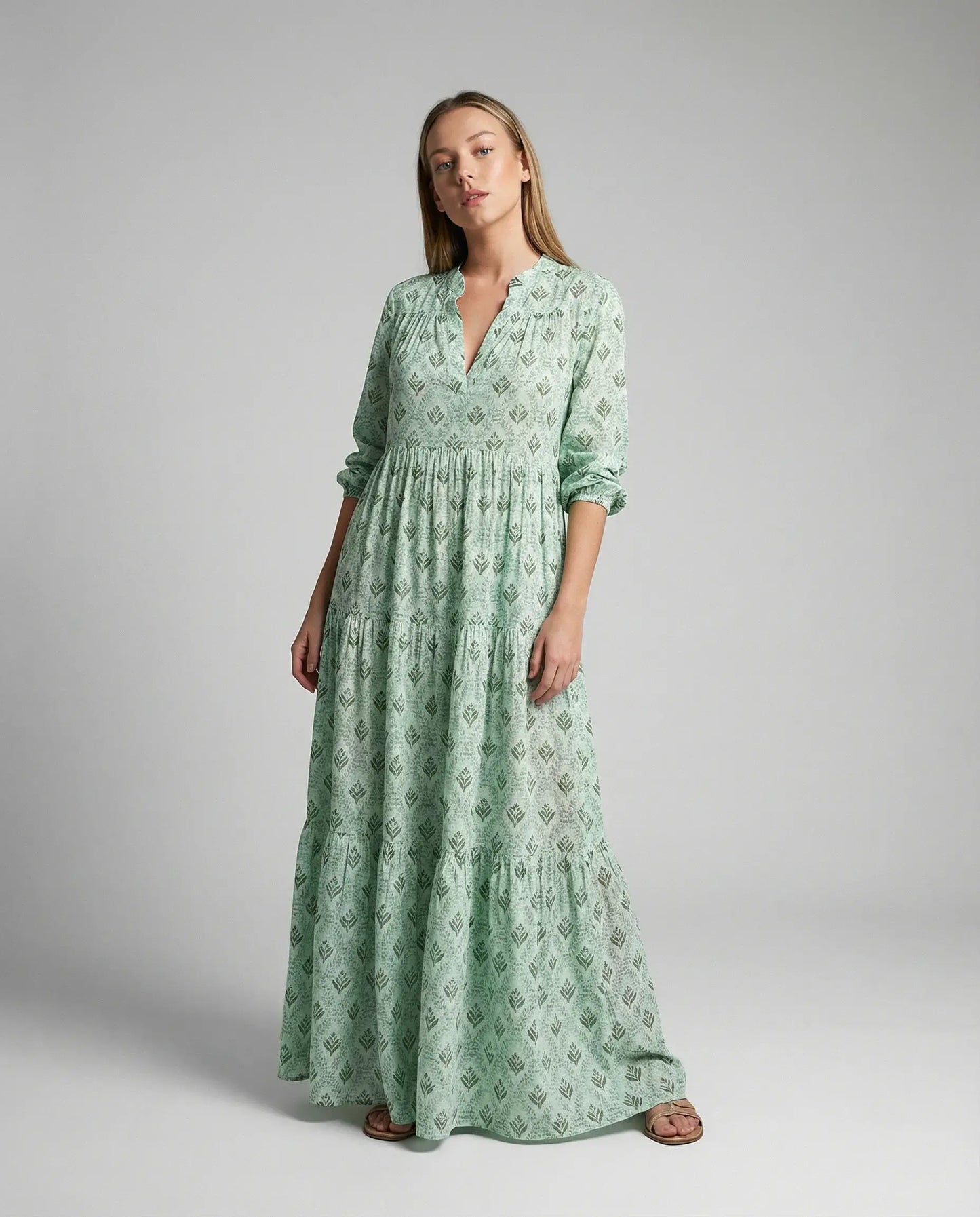 Women's boho print maxi dress in green by Ilynora, front view highlighting tiered design and airy silhouette