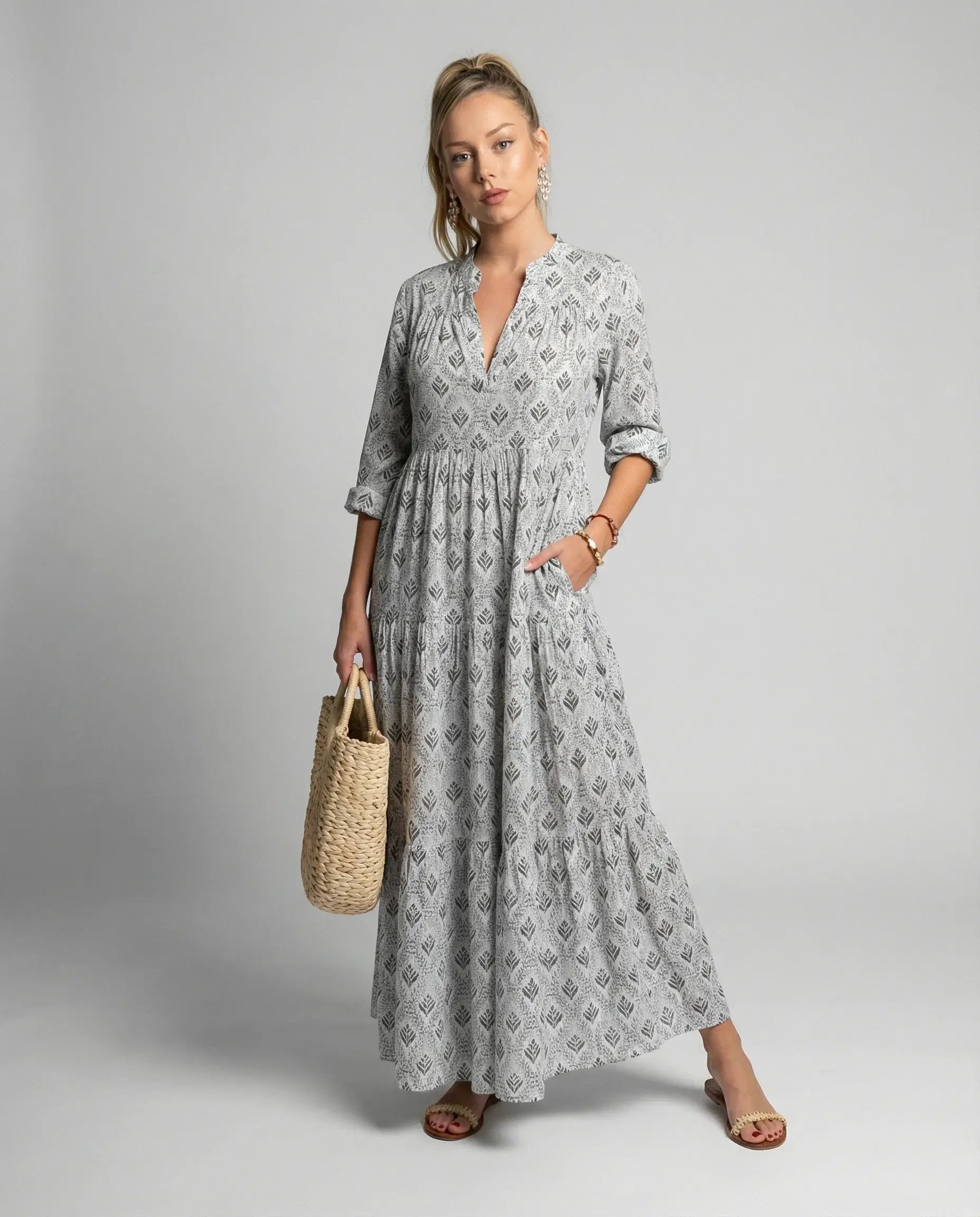 Women's boho print maxi dress in grey by Ilynora, front view with flowing silhouette and tiered skirt