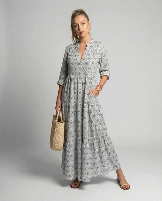 Women's boho print maxi dress in grey by Ilynora, front view with flowing silhouette and tiered skirt