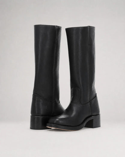 Women's black cowboy style leather boots with sleek knee-high profile and modern western appeal by ILYNORA