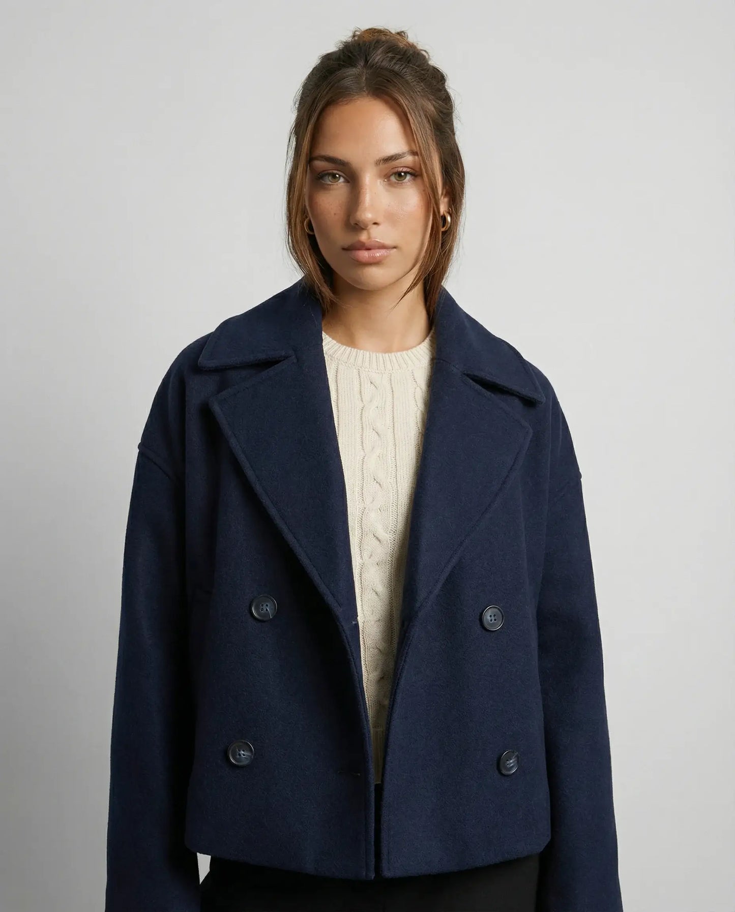 Navy blue cropped double-breasted jacket by Ilynora, front view with sharp lapels and refined silhouette