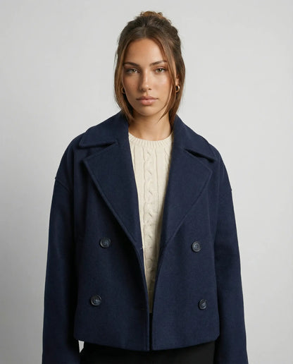 Navy blue cropped double-breasted jacket by Ilynora, front view with sharp lapels and refined silhouette