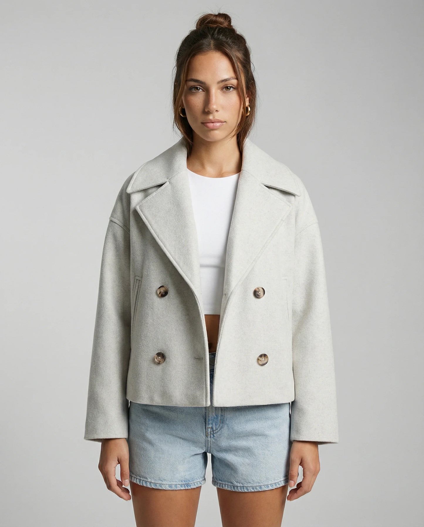 Women's cropped double-breasted jacket in white by Ilynora, front view with modern silhouette and structured fit