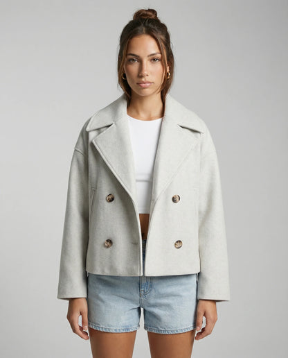 Women's cropped double-breasted jacket in white by Ilynora, front view with modern silhouette and structured fit