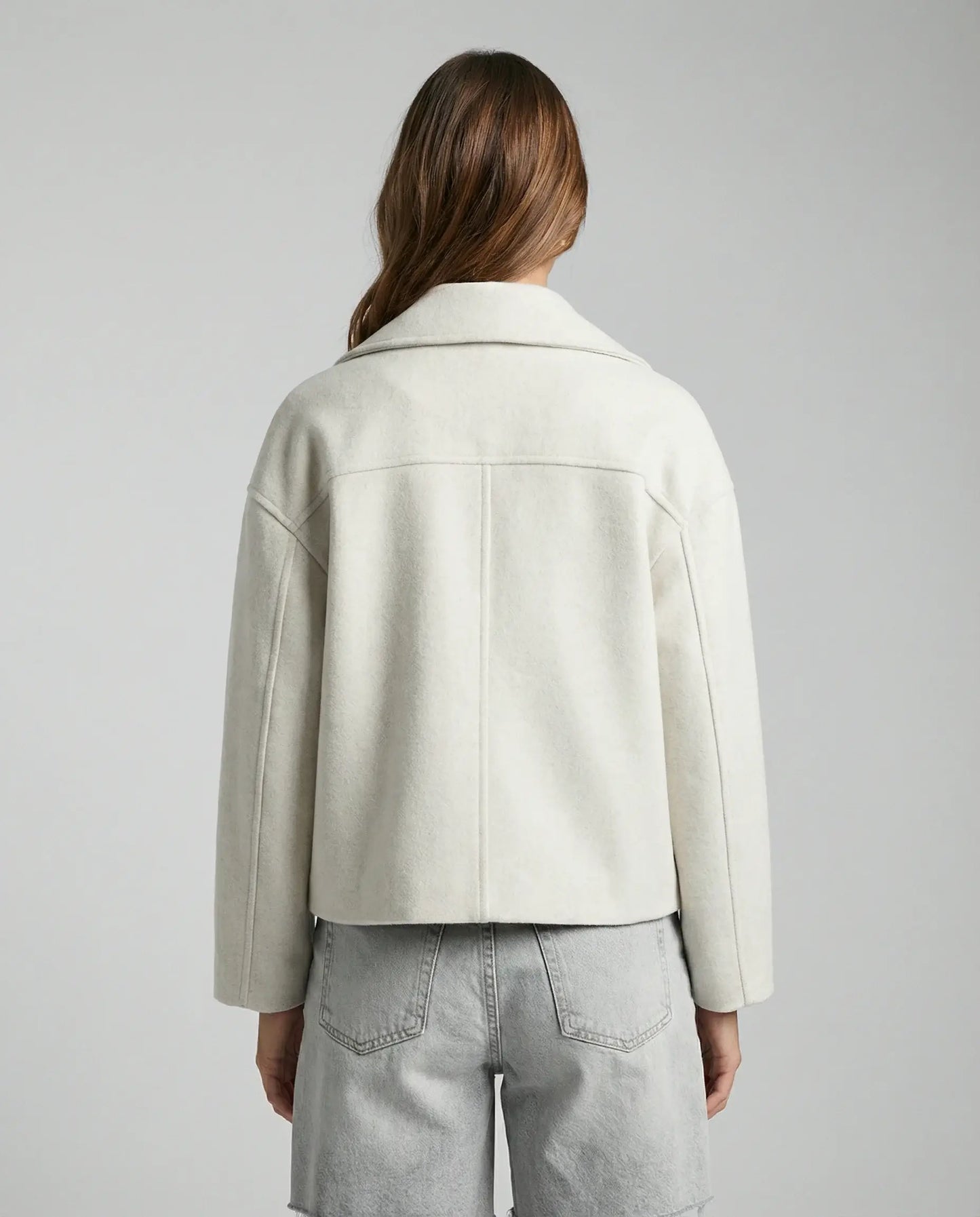 White cropped double-breasted jacket by Ilynora, back view showing clean lines and tailored design