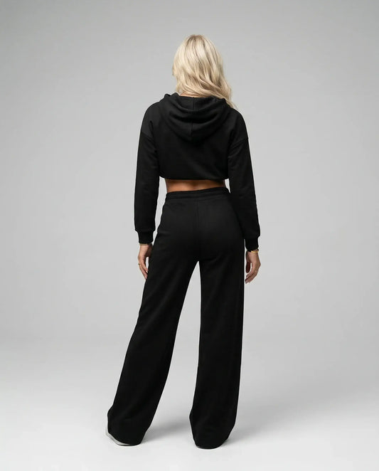 Black cropped hoodie tracksuit by Ilynora, back view highlighting wide leg trousers and clean design