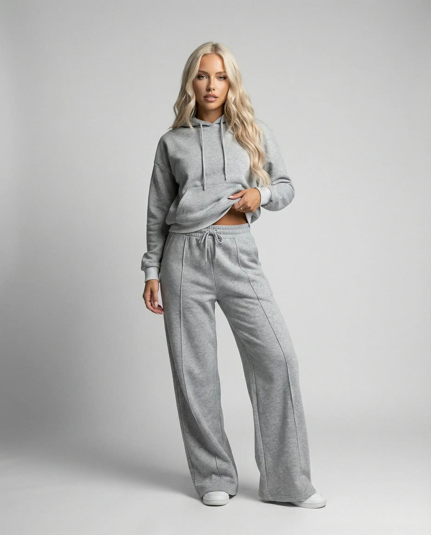 Grey cropped hoodie tracksuit for women by Ilynora, front view with wide leg pants and minimal design