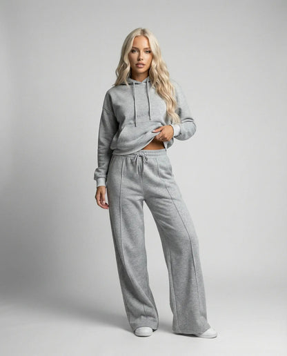 Grey cropped hoodie tracksuit for women by Ilynora, front view with wide leg pants and minimal design