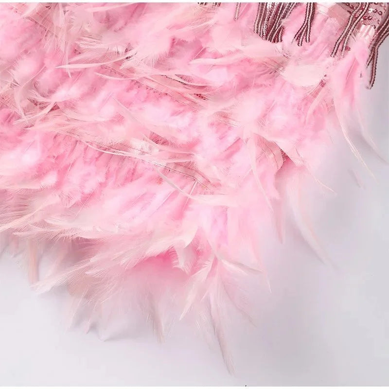 Feather trim mini dress in pink by Ilynora, fabric detail highlighting layered fringe and texture