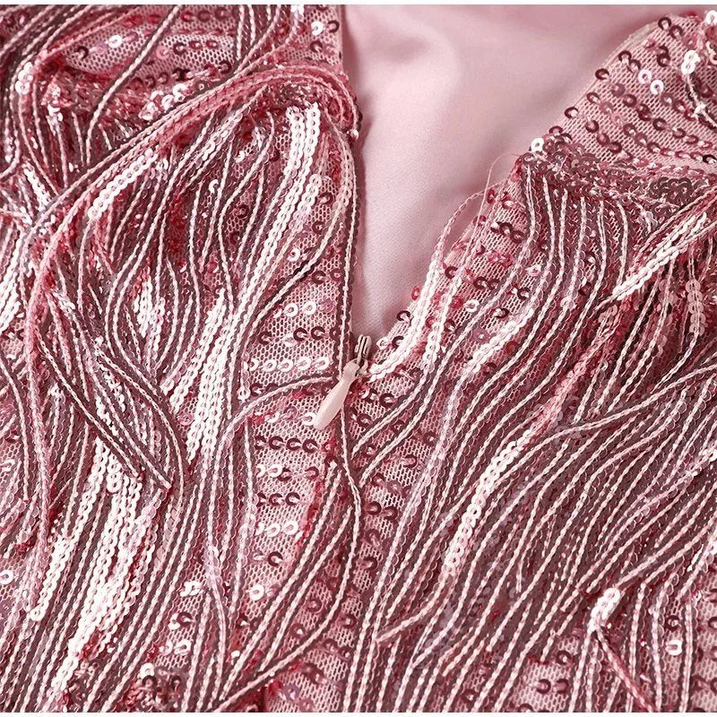 Pink fringe mini dress by Ilynora, back view highlighting feather trim and movement