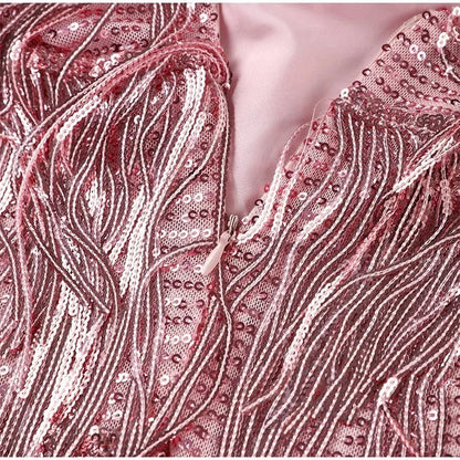 Pink fringe mini dress by Ilynora, back view highlighting feather trim and movement