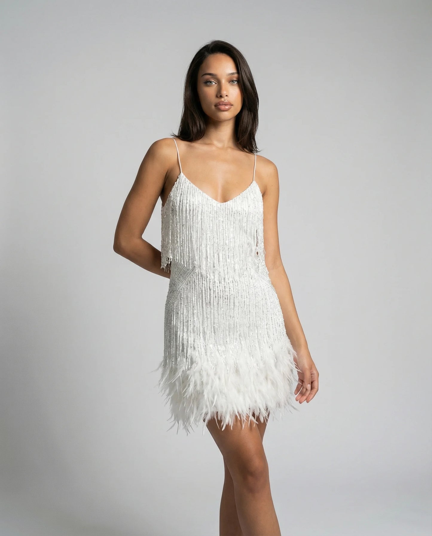 Women's feather trim fringe mini dress in white by Ilynora, front view with slim fit and soft movement
