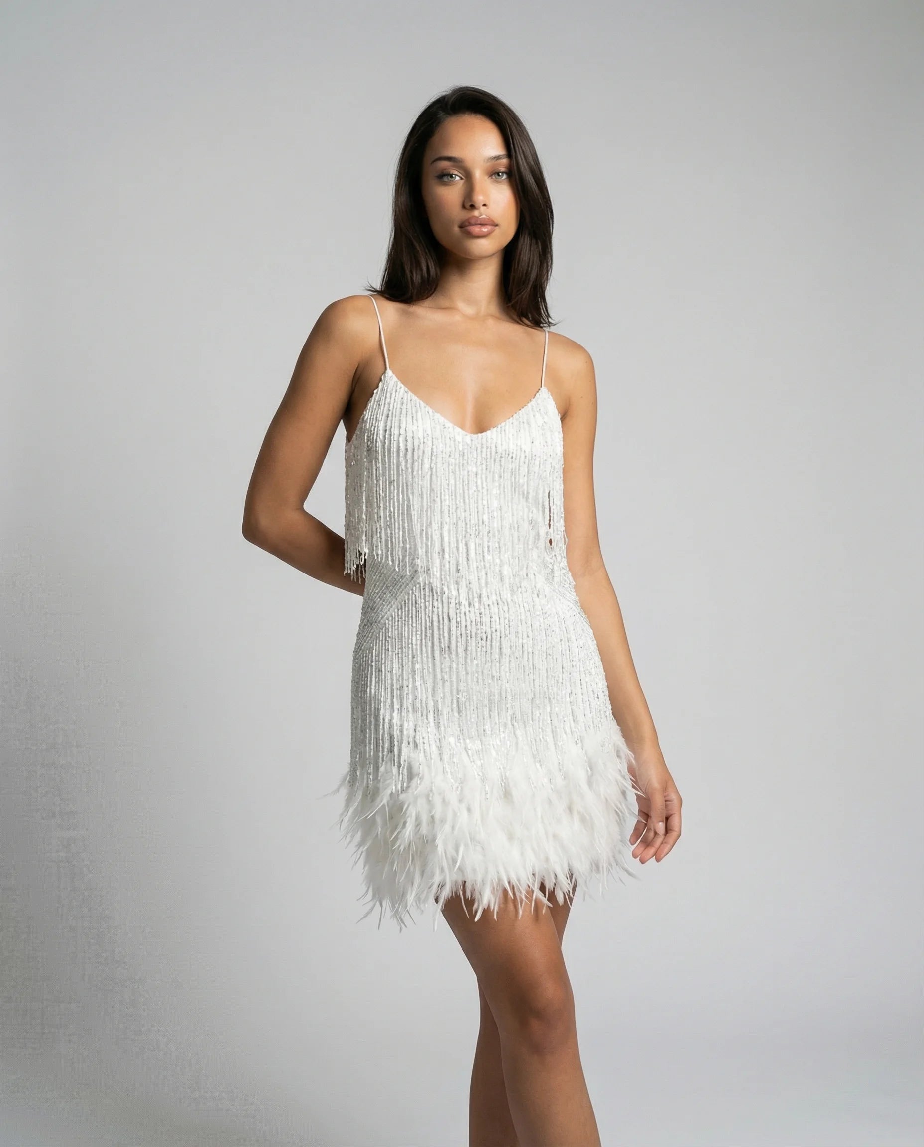 Women's feather trim fringe mini dress in white by Ilynora, front view with slim fit and soft movement