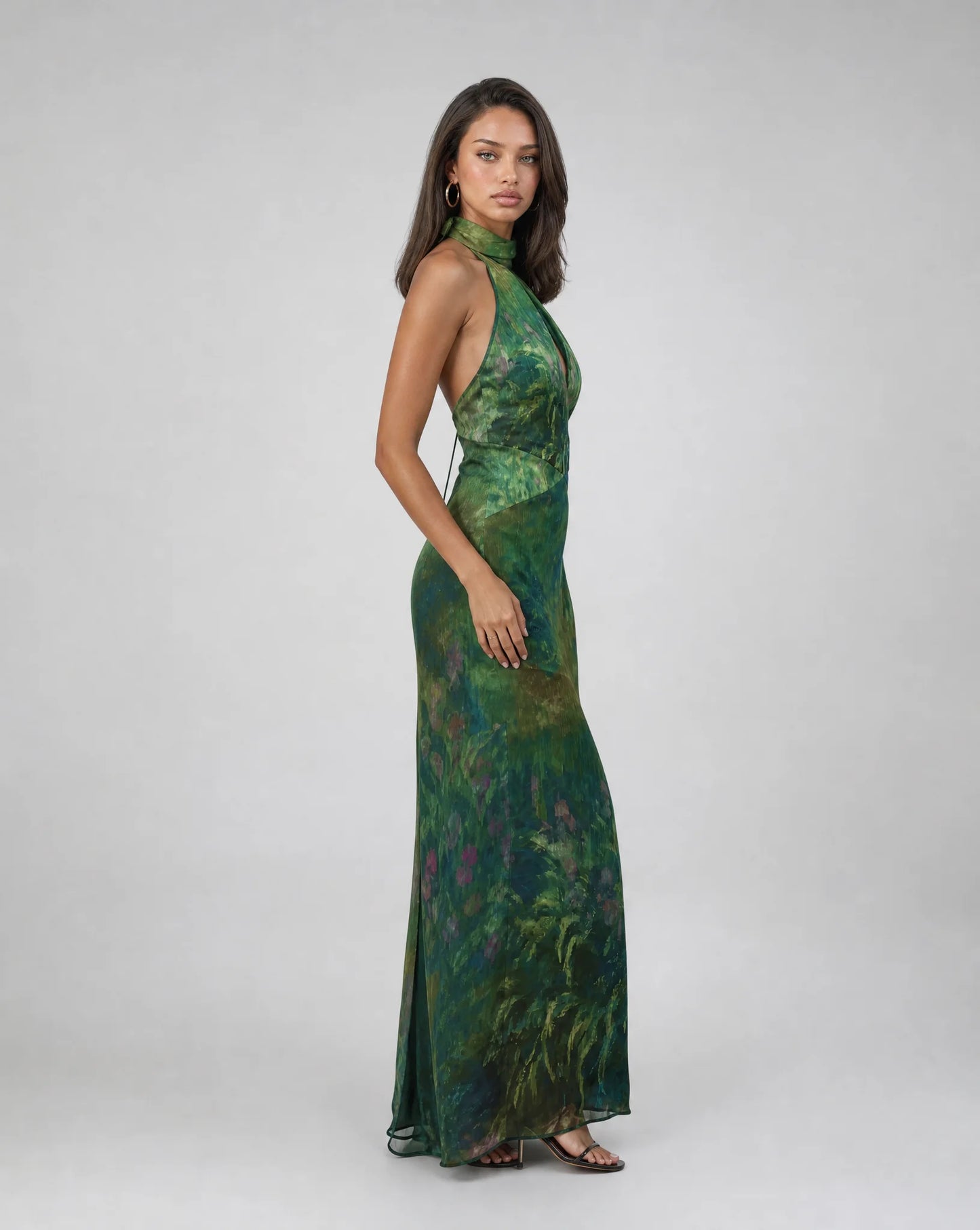 Women's dark green floral occasion dress with halter neckline and sophisticated evening style by ILYNORA