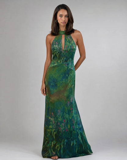 Women's dark green floral occasion maxi dress with artistic print and elegant flowing silhouette by ILYNORA