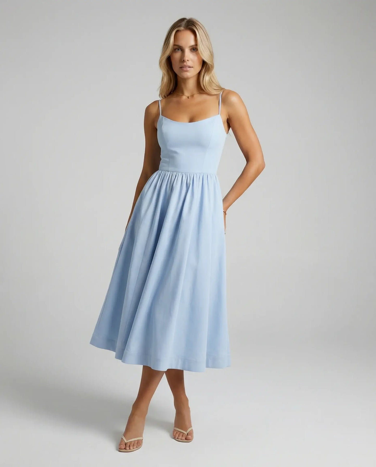 Light blue flowy midi dress by Ilynora, front view with soft flow and summer-ready look