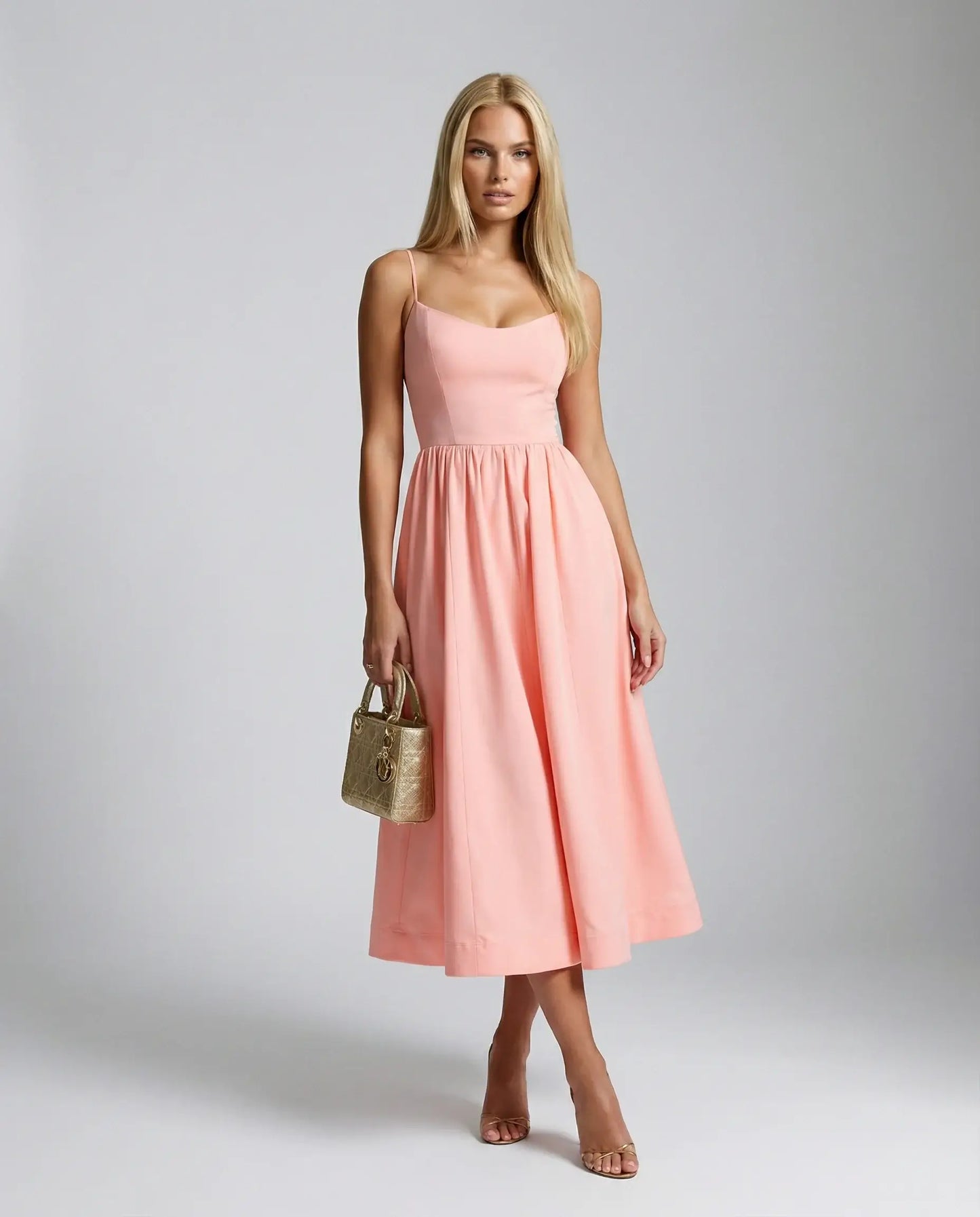 Pink flowy midi dress by Ilynora, front view with airy fit and feminine silhouette