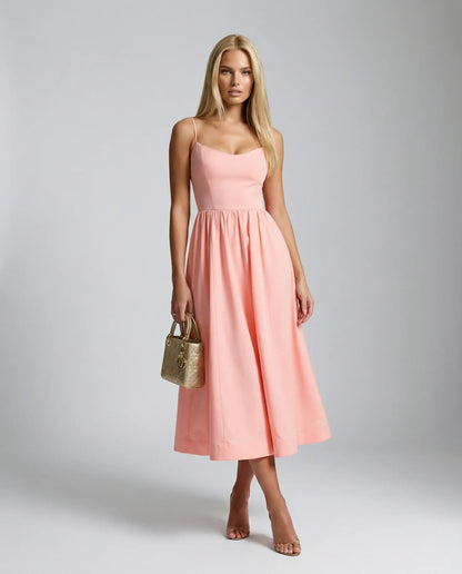 Pink flowy midi dress by Ilynora, front view with airy fit and feminine silhouette