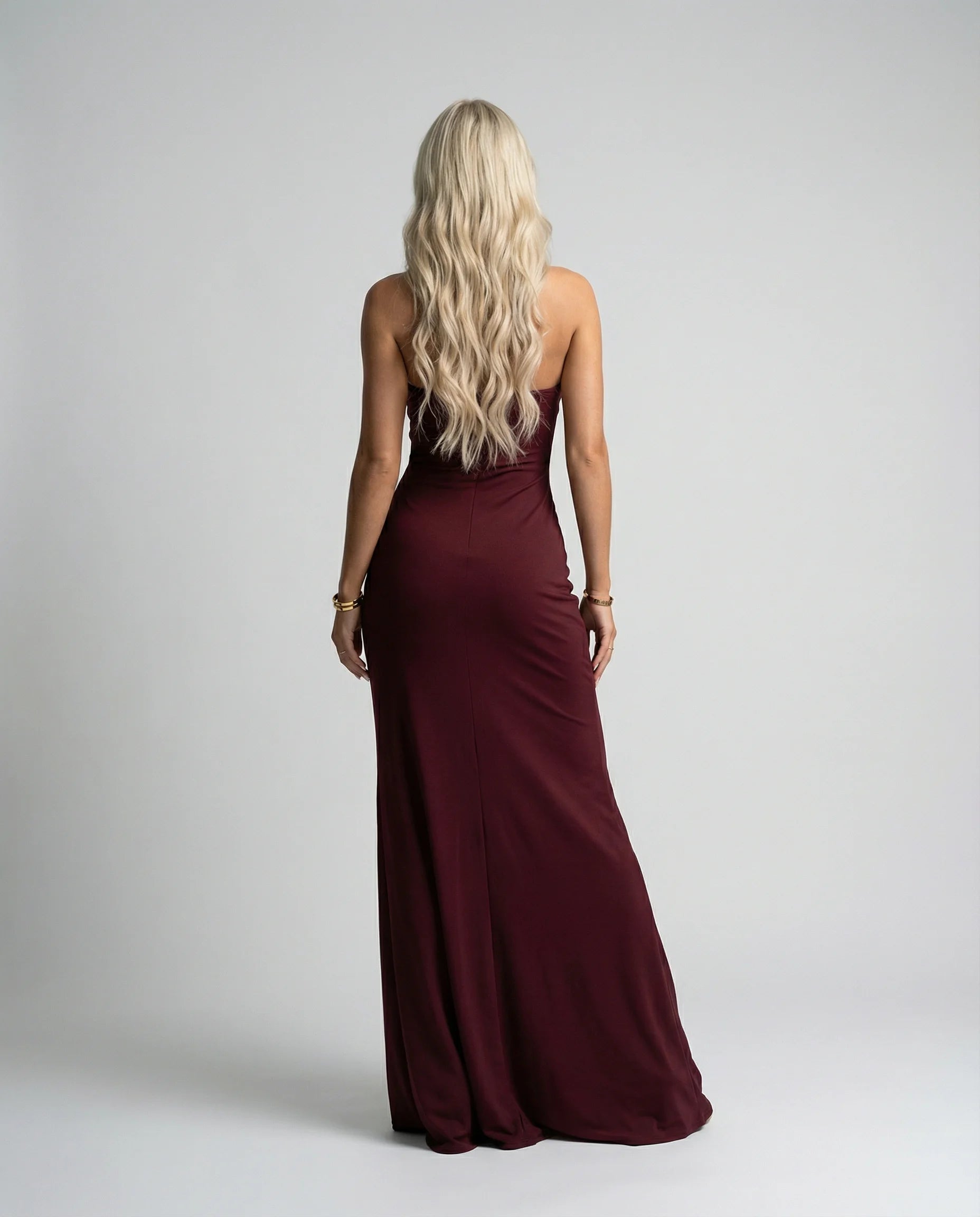 Burgundy halter neck maxi dress by Ilynora, back view with fitted shape and flowing movement