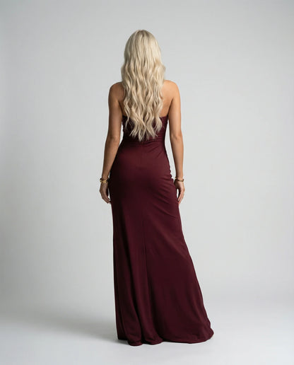 Burgundy halter neck maxi dress by Ilynora, back view with fitted shape and flowing movement
