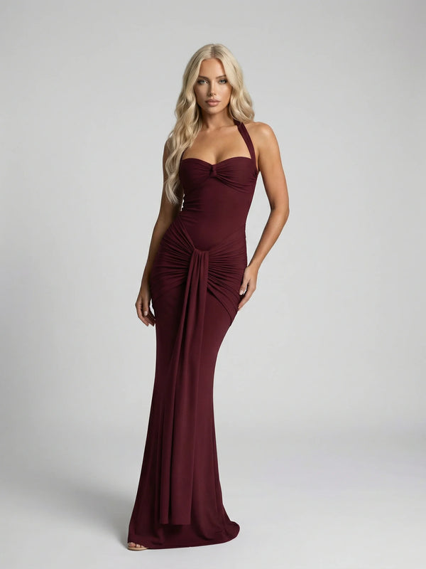Burgundy halter neck maxi dress by Ilynora, front view with ruched detail and elegant floor-length silhouette