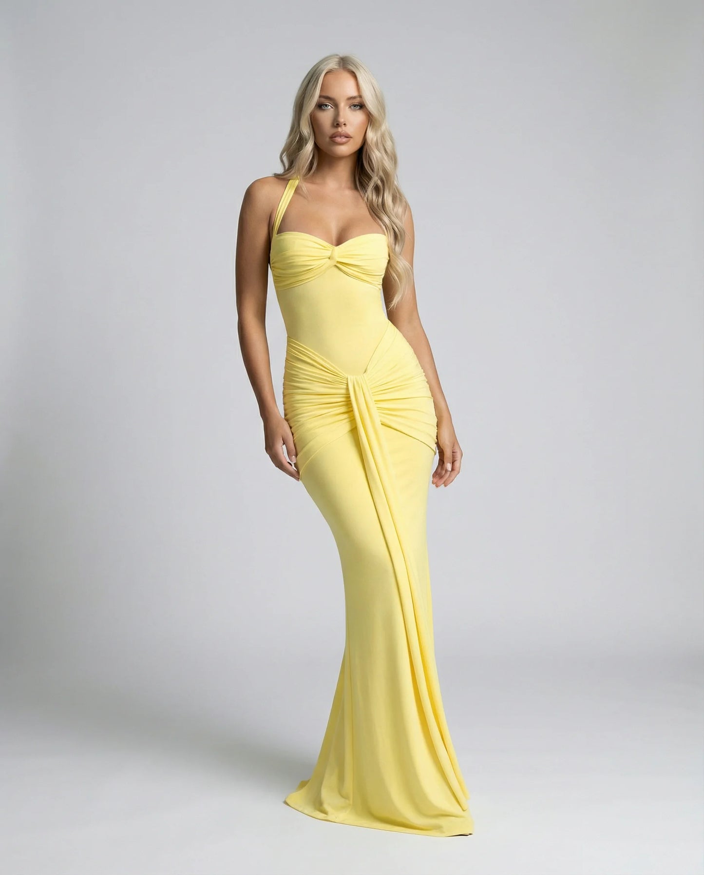 Yellow halter neck maxi dress by Ilynora, front view with ruched detail and soft flowing design