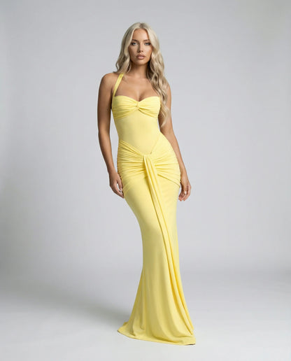 Yellow halter neck maxi dress by Ilynora, front view with ruched detail and soft flowing design