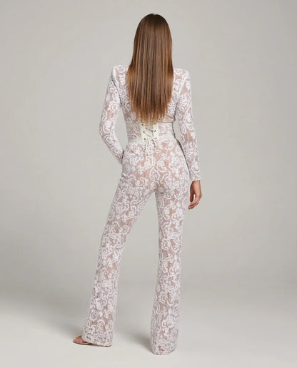 White lace flare jumpsuit by Ilynora, back view highlighting sculpted waist and elegant silhouette