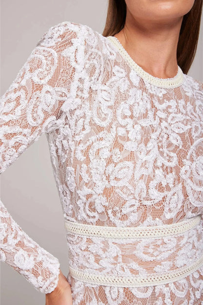 Lace flare leg jumpsuit in white by Ilynora, close-up showing intricate floral lace detailing