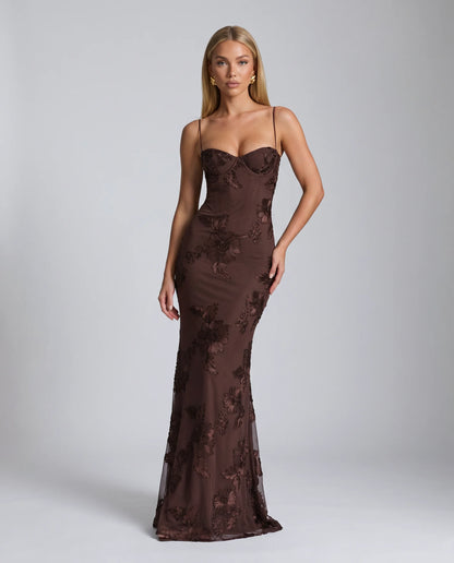 Brown floral lace up back maxi dress with fitted bodice and sophisticated evening styling by ILYNORA