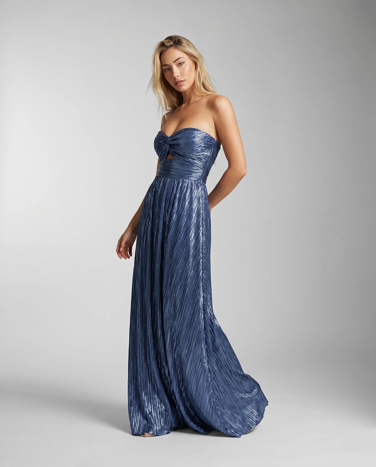 Blue metallic pleated maxi dress side view with elegant drape and formal occasion styling by ILYNORA