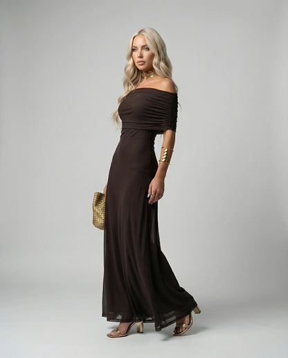 Black sheer off-shoulder maxi dress by Ilynora, full-length view highlighting lightweight layers and movement