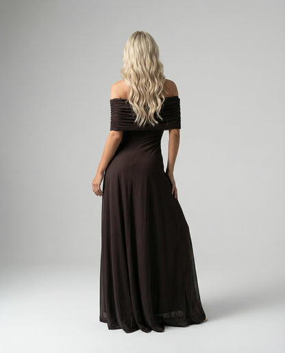 Black off-shoulder sheer maxi dress for women by Ilynora, angled view showing flowing fabric and feminine fit