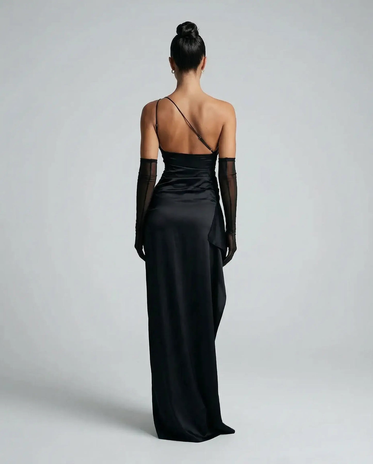 Black one-shoulder satin maxi dress for women by Ilynora, back view showing smooth satin drape and elegant shape