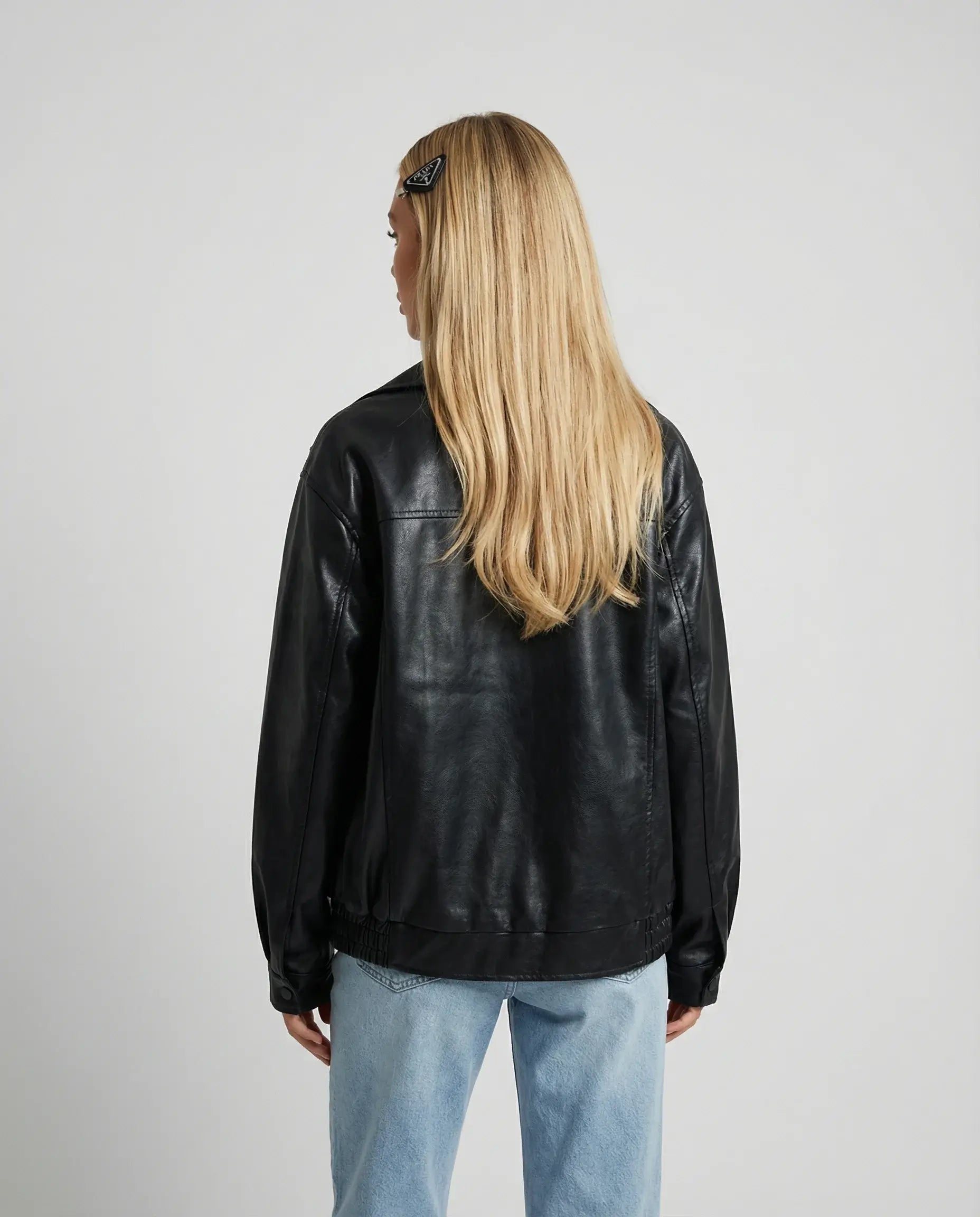 Black oversized leather jacket by Ilynora, back view highlighting clean design and modern shape