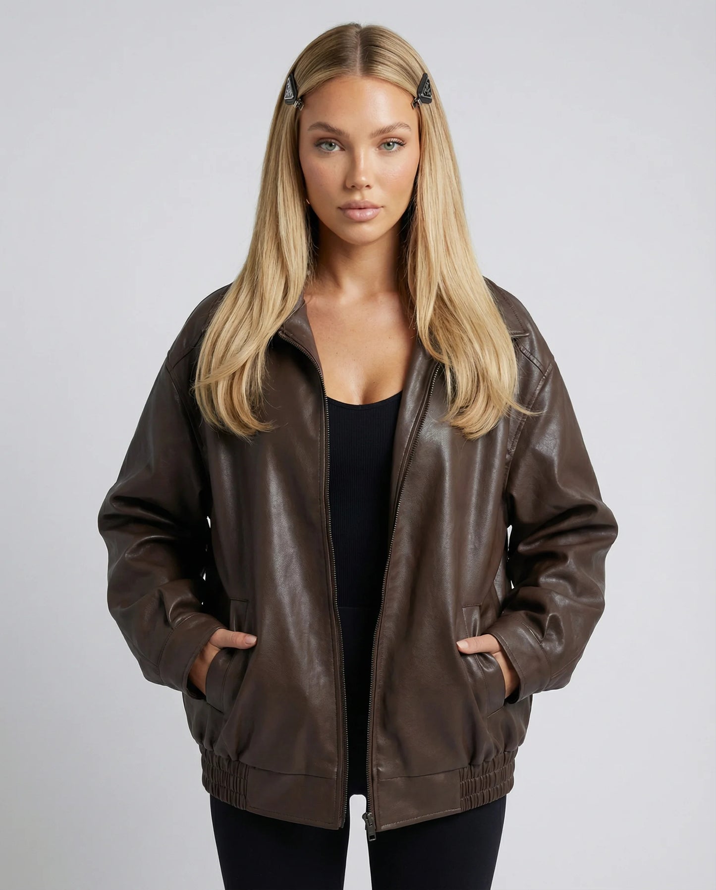 Women's oversized leather jacket in brown by Ilynora, front view with relaxed silhouette and smooth finish