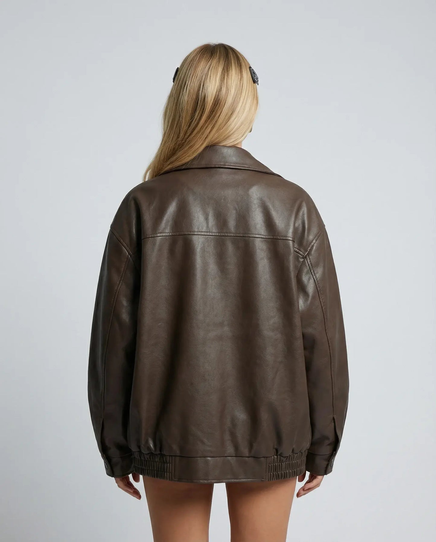 Brown oversized leather jacket by Ilynora, back view showing loose fit and minimal design