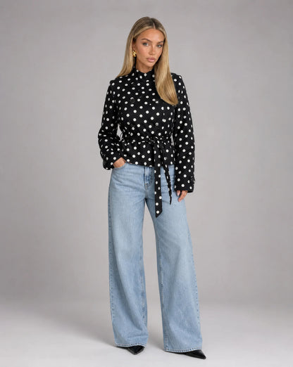 Women's black and white polka dot jacket styled with wide leg jeans and chic everyday look by ILYNORA