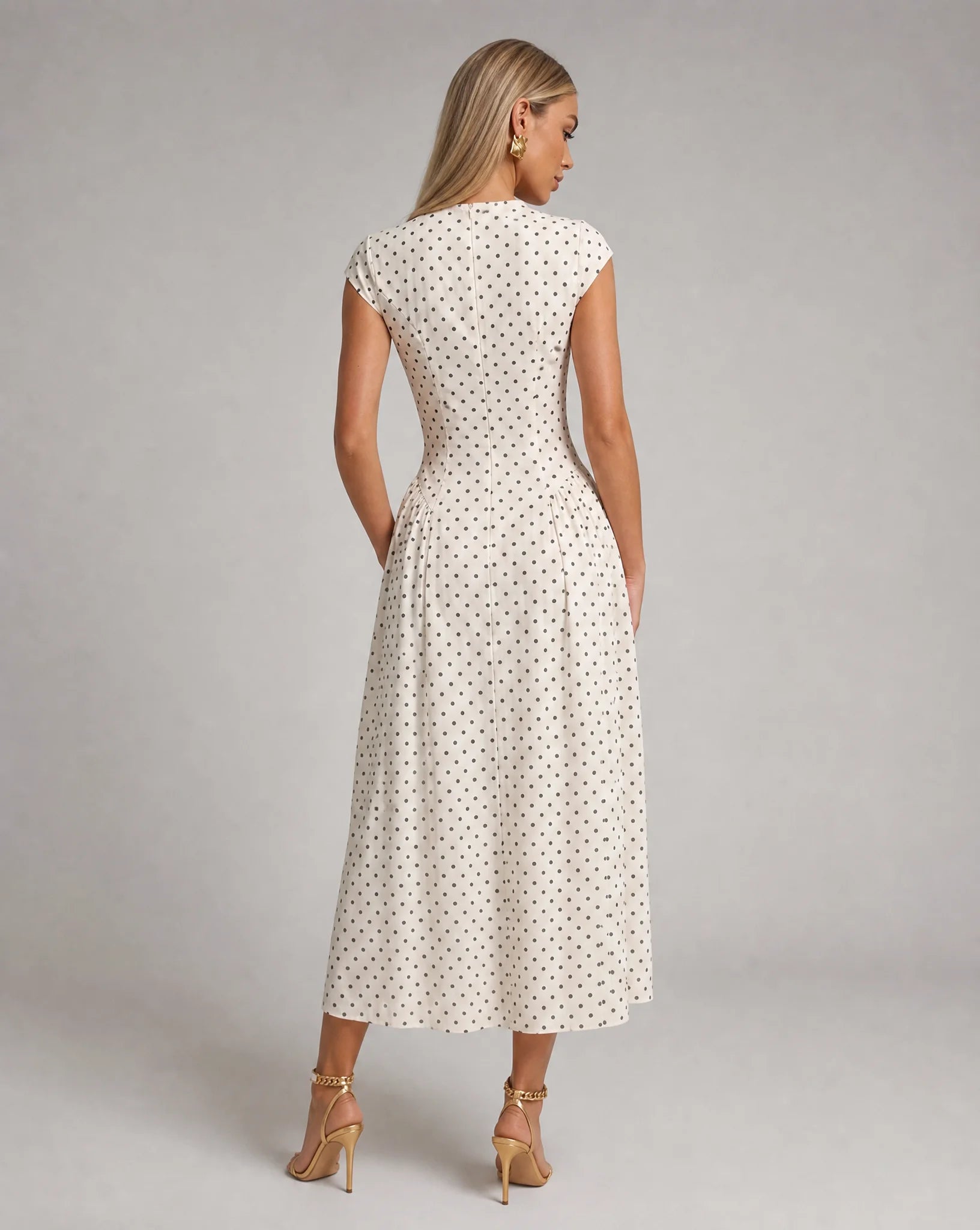White polka dot fit and flare midi dress back view with flowing A-line skirt and feminine silhouette by ILYNORA