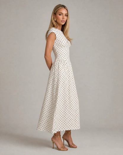 White polka dot fit and flare midi dress side view with fitted bodice and timeless occasion wear by ILYNORA