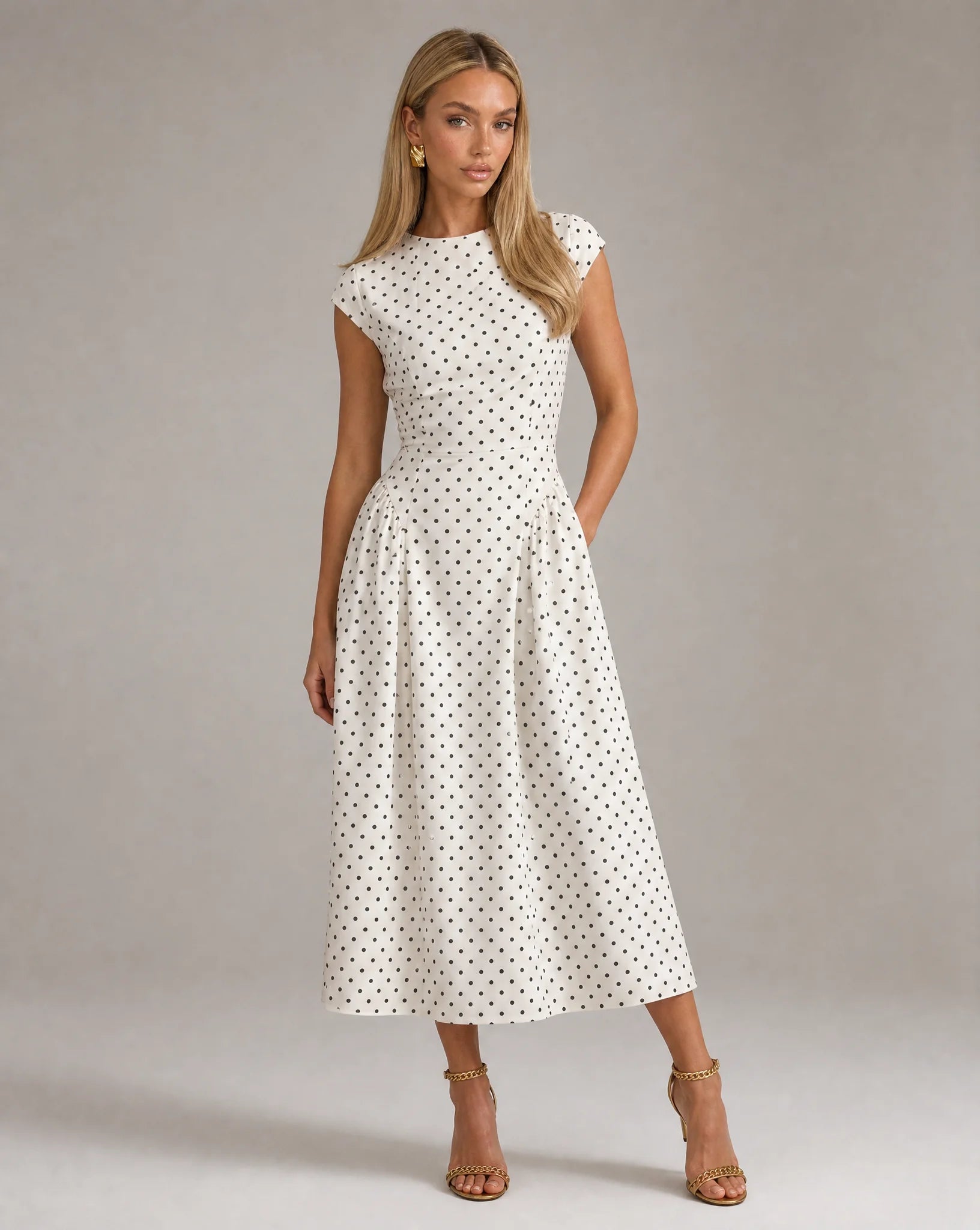 White polka dot fit and flare midi dress with cap sleeves and elegant wedding guest styling by ILYNORA