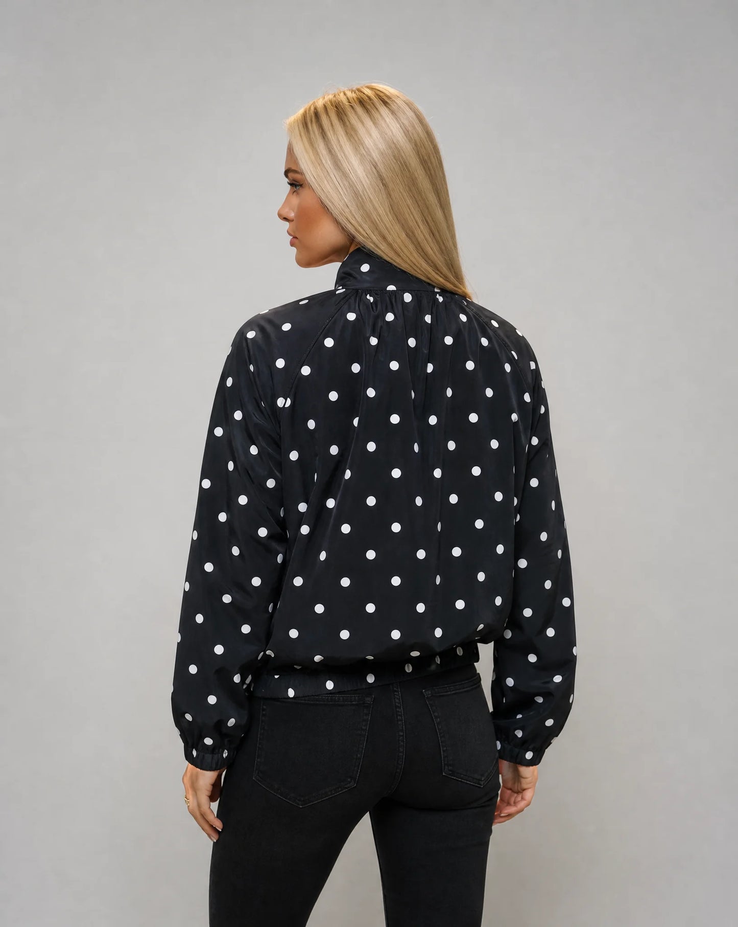 Women's black polka dot windbreaker jacket with comfortable fit and chic transitional layering by ILYNORA