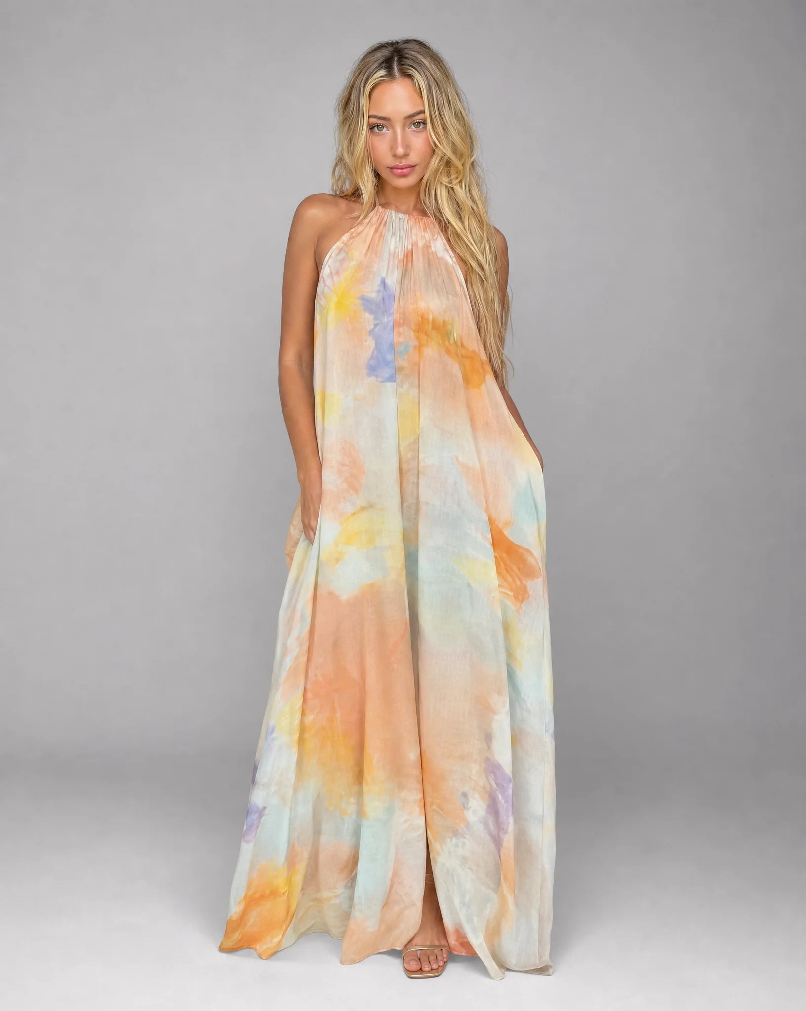 Orange printed halter maxi dress with open back detail and watercolour inspired print by ILYNORA