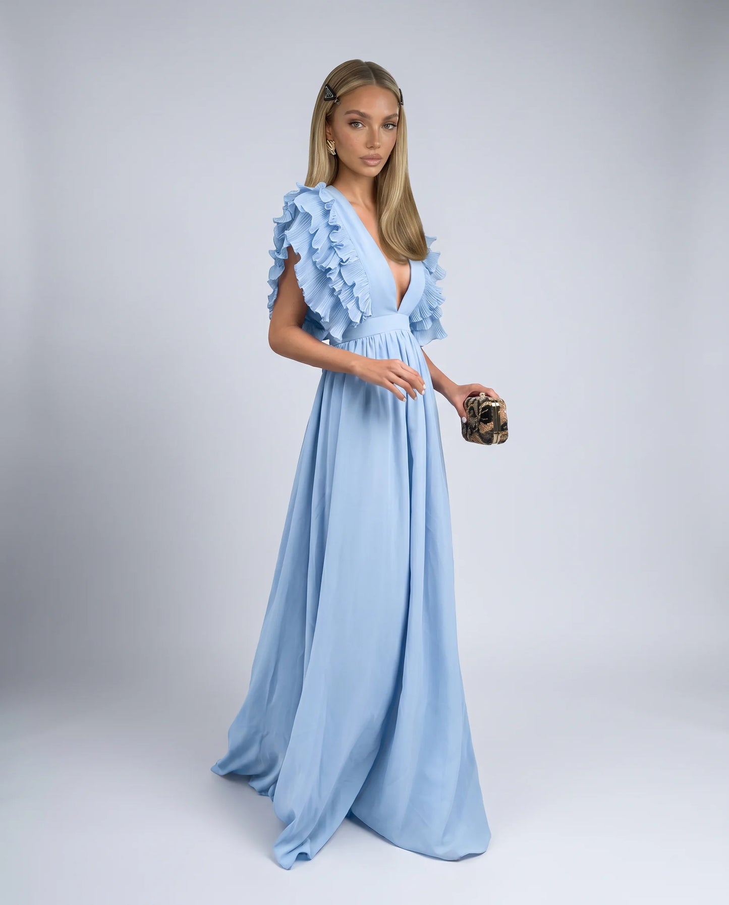 Blue ruffle sleeve maxi dress with deep V neckline and flowing skirt for wedding guests by ILYNORA