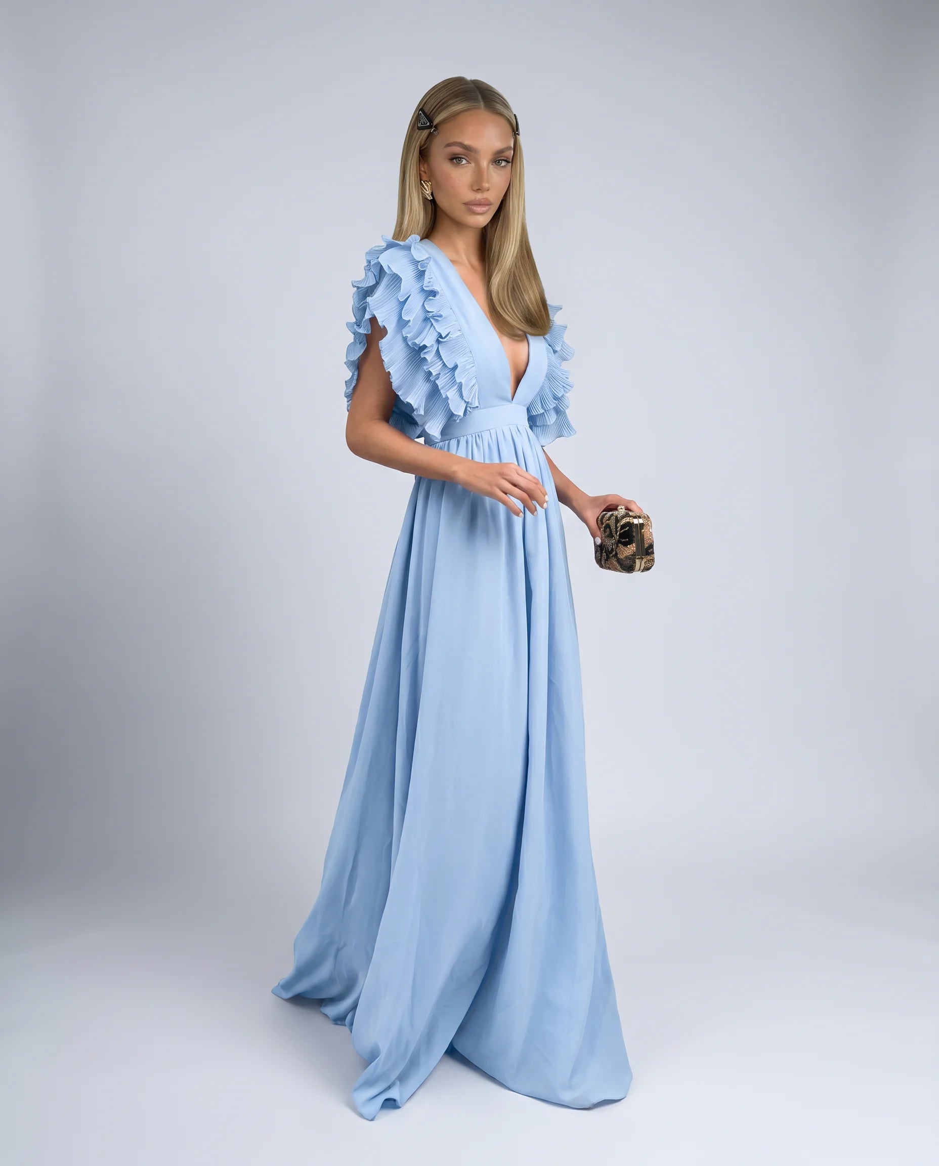 Blue ruffle sleeve maxi dress with deep V neckline and flowing skirt for wedding guests by ILYNORA