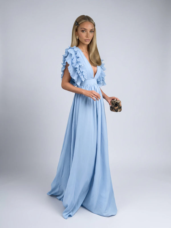 Blue ruffle sleeve maxi dress with deep V neckline and flowing skirt for wedding guests by ILYNORA
