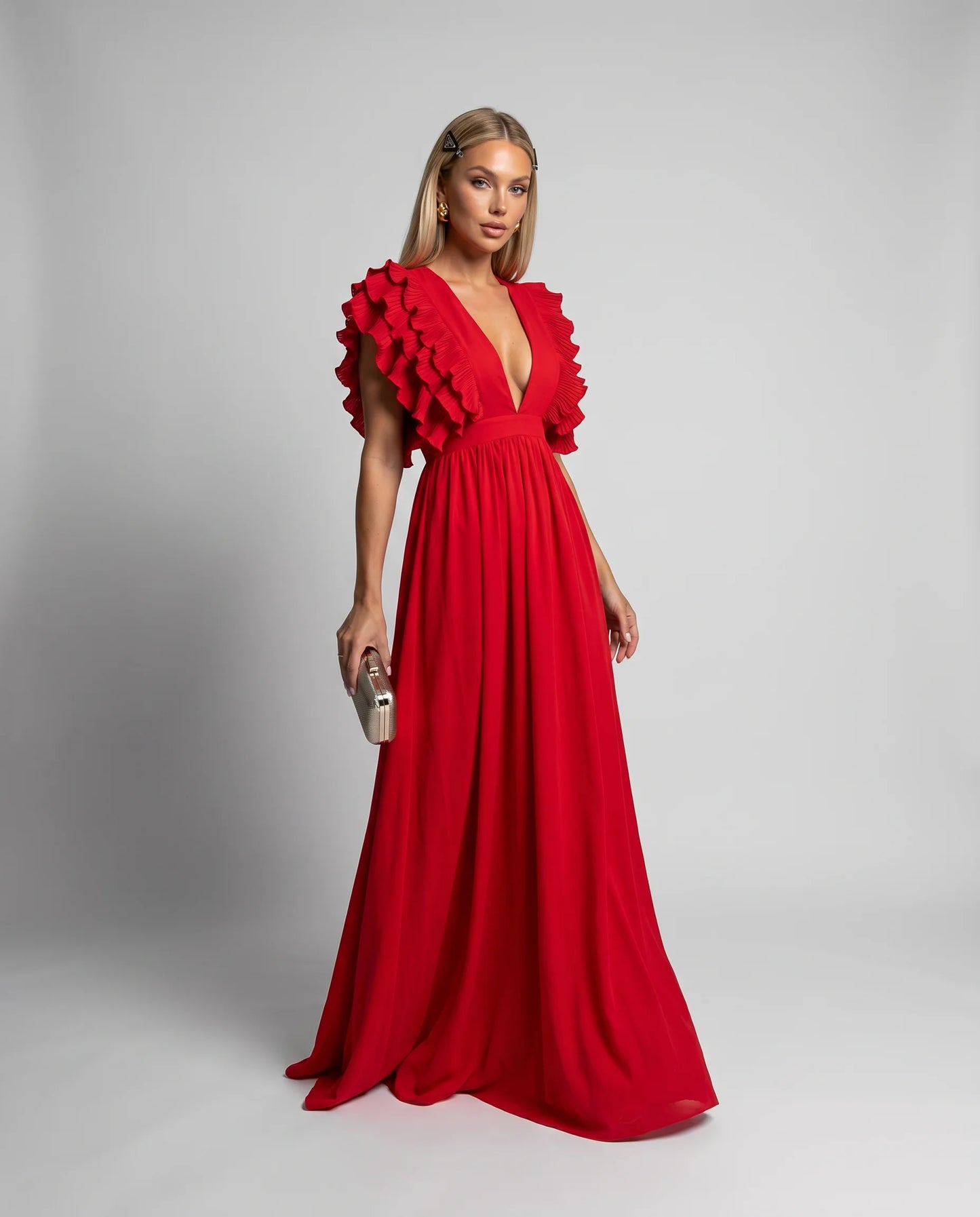 Red ruffle sleeve maxi dress with plunging neckline and flowing floor length silhouette by ILYNORA