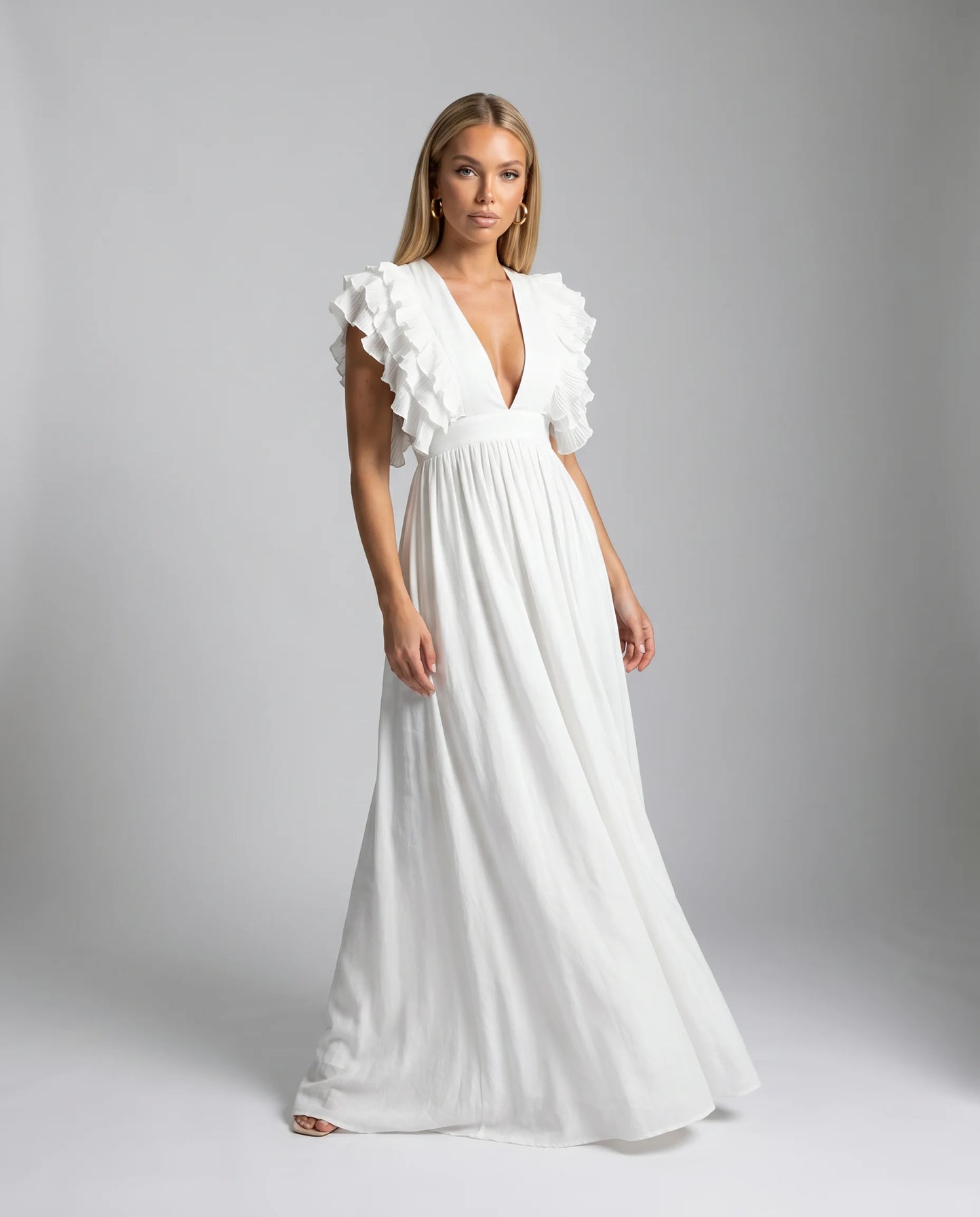 White ruffle sleeve maxi dress with feminine drape and elegant bridal inspired styling by ILYNORA